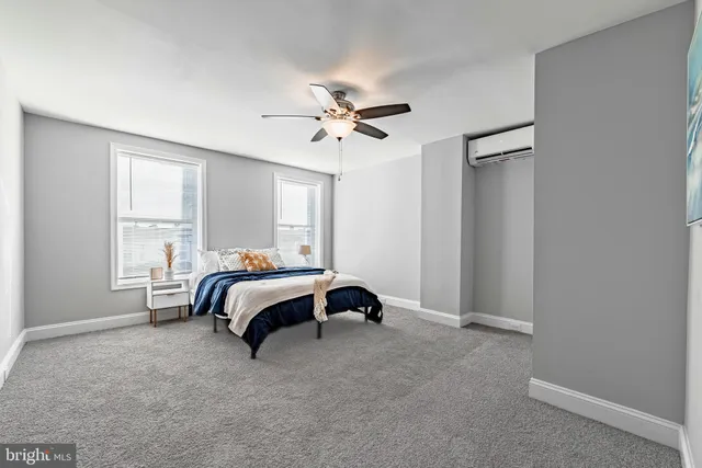 a bedroom with a bed and a ceiling fan