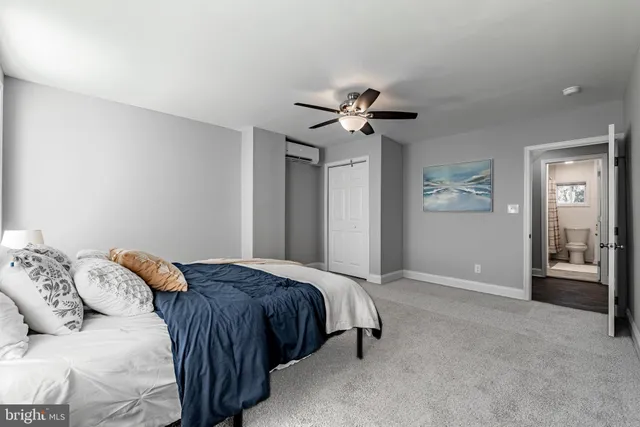 a bedroom with a large bed and a chandelier