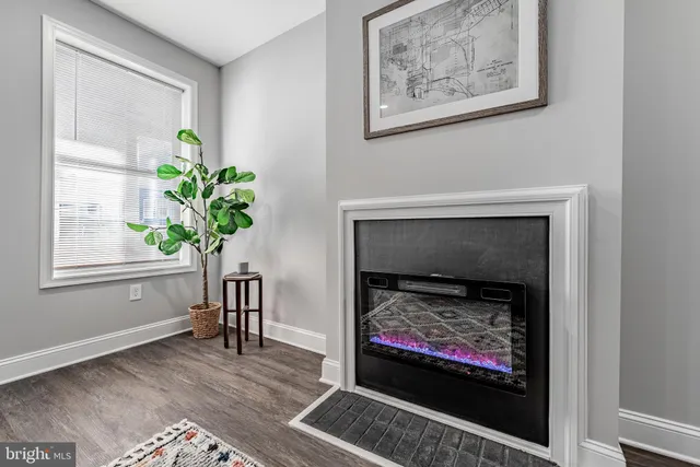 a living room with a fireplace and a potted plant
