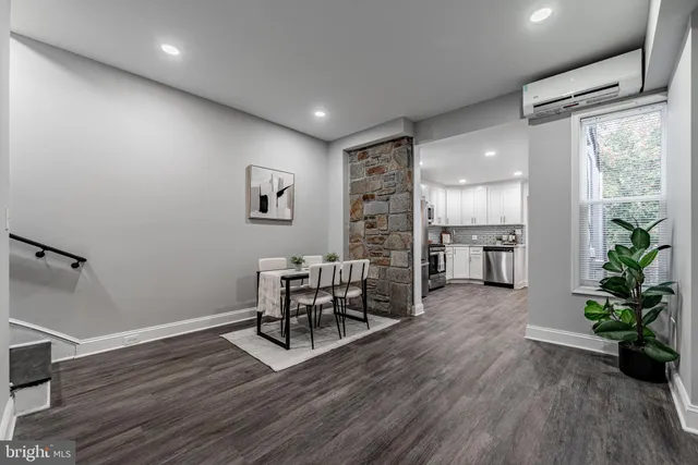 a view of a work space with furniture and wooden floor