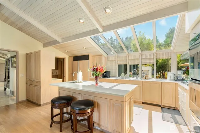 a dining hall with stainless steel appliances granite countertop a stove and a refrigerator