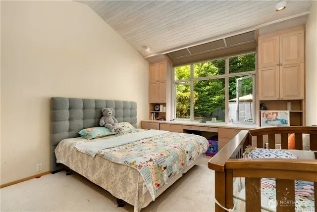 a bedroom with a bed and window