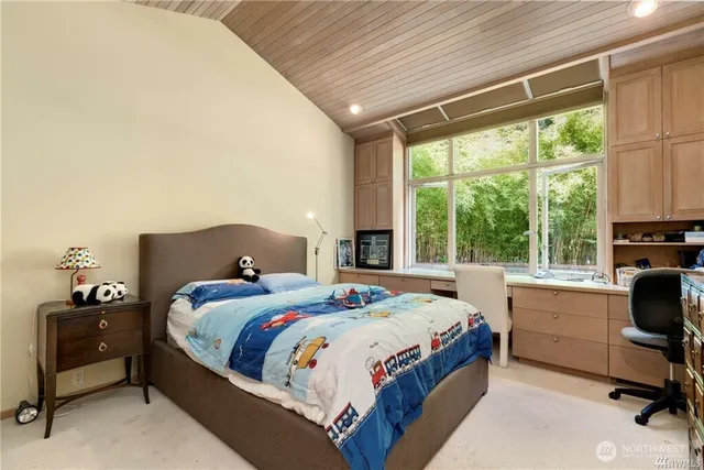 a bedroom with a bed and a desk