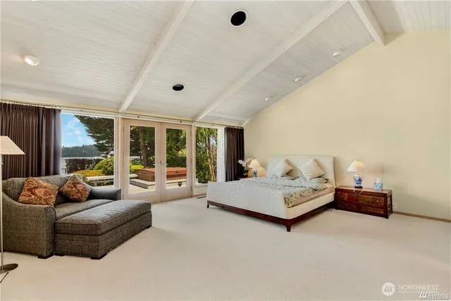 a living room with furniture and large windows