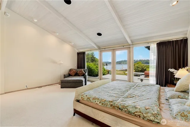 a bedroom with a large bed and a large window