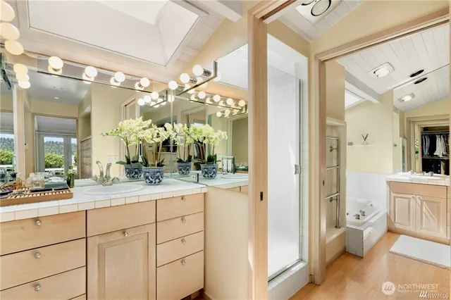 a bathroom with a double vanity sink and a mirror