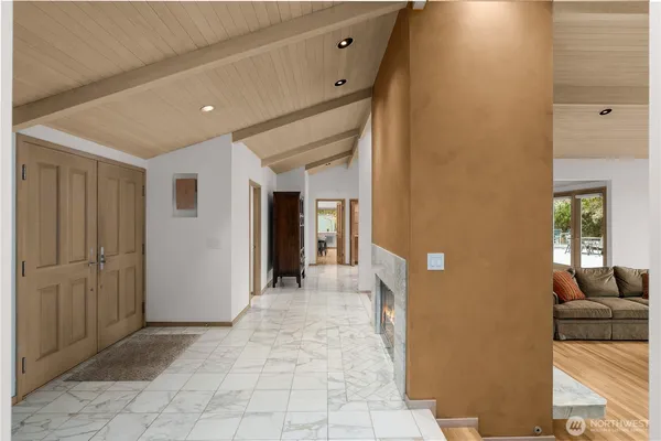 a view of a hallway with furniture and front door