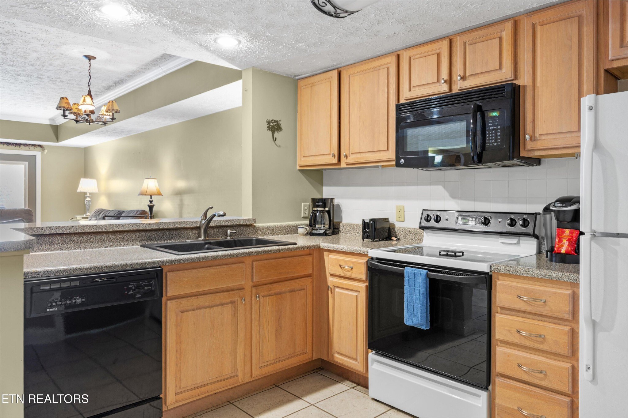 818 Golf View Boulevard, Unit 1502 Sevierville, TN 37863 - Photo 7 of 27 a kitchen with stainless steel appliances granite countertop a stove top oven a sink dishwasher and white cabinets with wooden floor