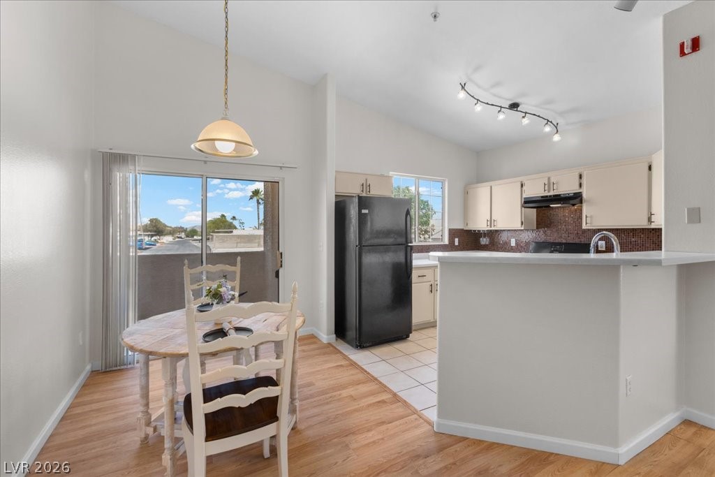 1881 West Alexander Road, Unit 1037 North Las Vegas, NV 89032 - Photo 4 of 31 A well-appointed kitchen and dining space with natural light and easy outdoor access. Additional seating available at the breakfast counter!
