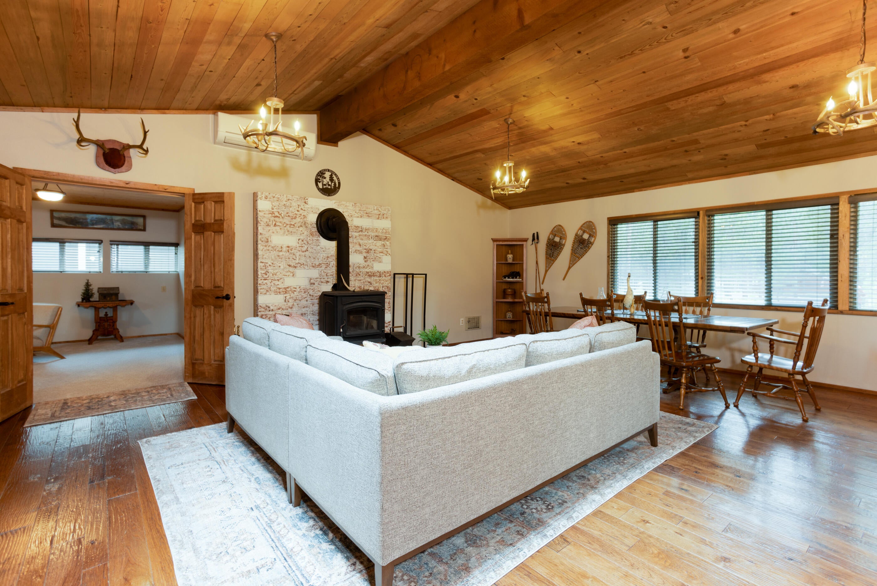 18155 Timber Lane Sunriver, OR 97707 - Photo 4 of 26 Vaulted cedar ceilings, with new deer antler light fixtures, and wood burning stove