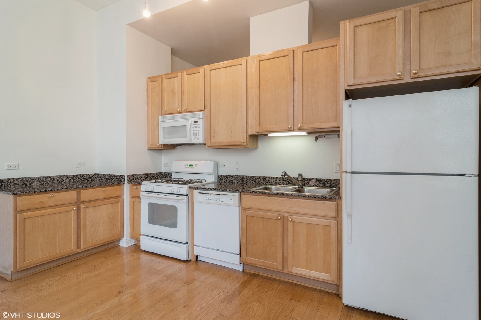 8 West Monroe Street, Unit 705 Chicago, IL 60603 - Photo 4 of 10 a kitchen with stainless steel appliances granite countertop a refrigerator and a stove top oven