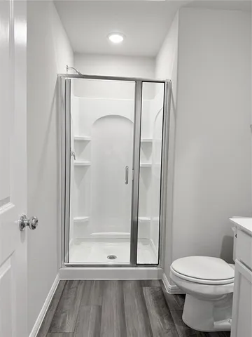 a bathroom with a glass shower door