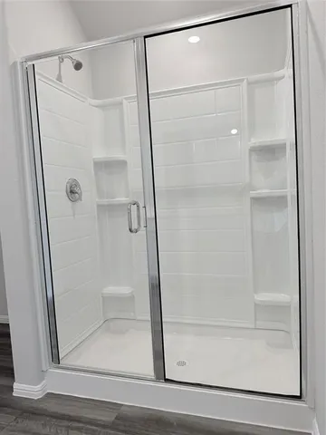 a bathroom with a glass shower door