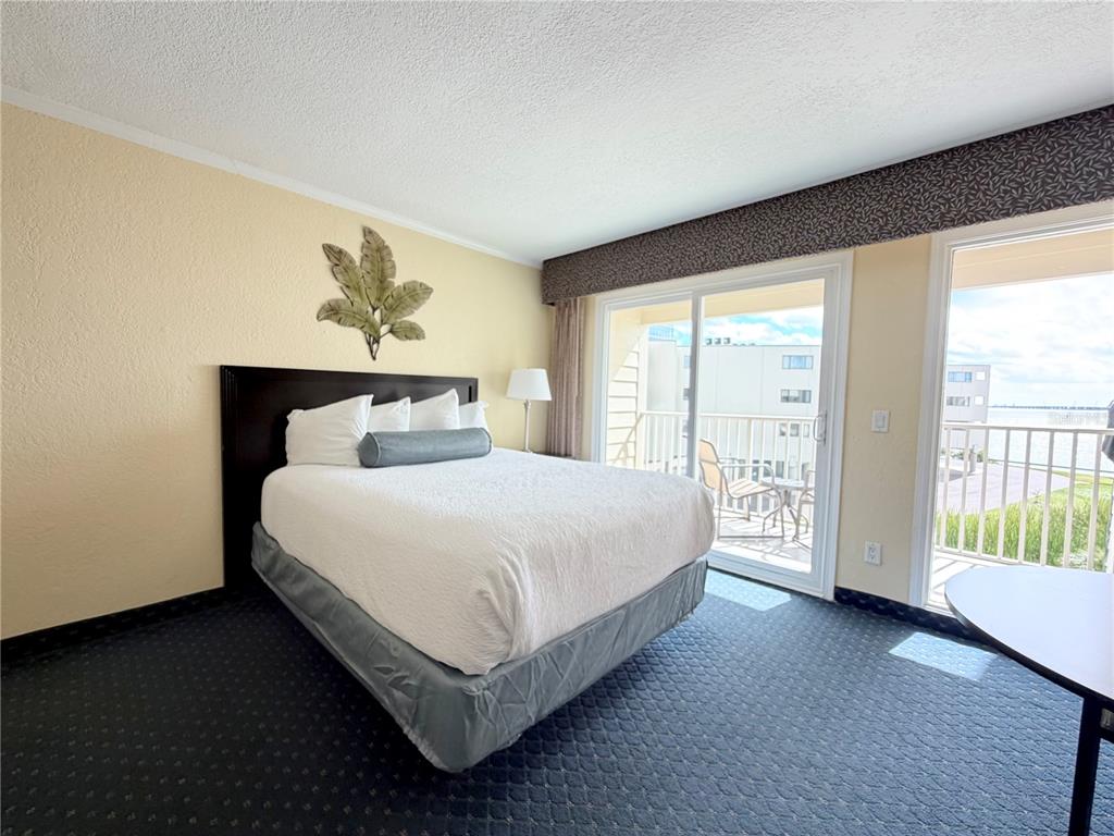 2506 North Rocky Point Drive, Unit 305 Tampa, FL 33607 - Photo 8 of 13 a spacious bedroom with a bed and a large window
