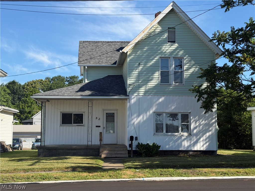 32 Cherry Road Northwest Massillon, OH 44646 - Photo 1 of 12 Two-story property featuring a gabled roof and light green siding on the upper level