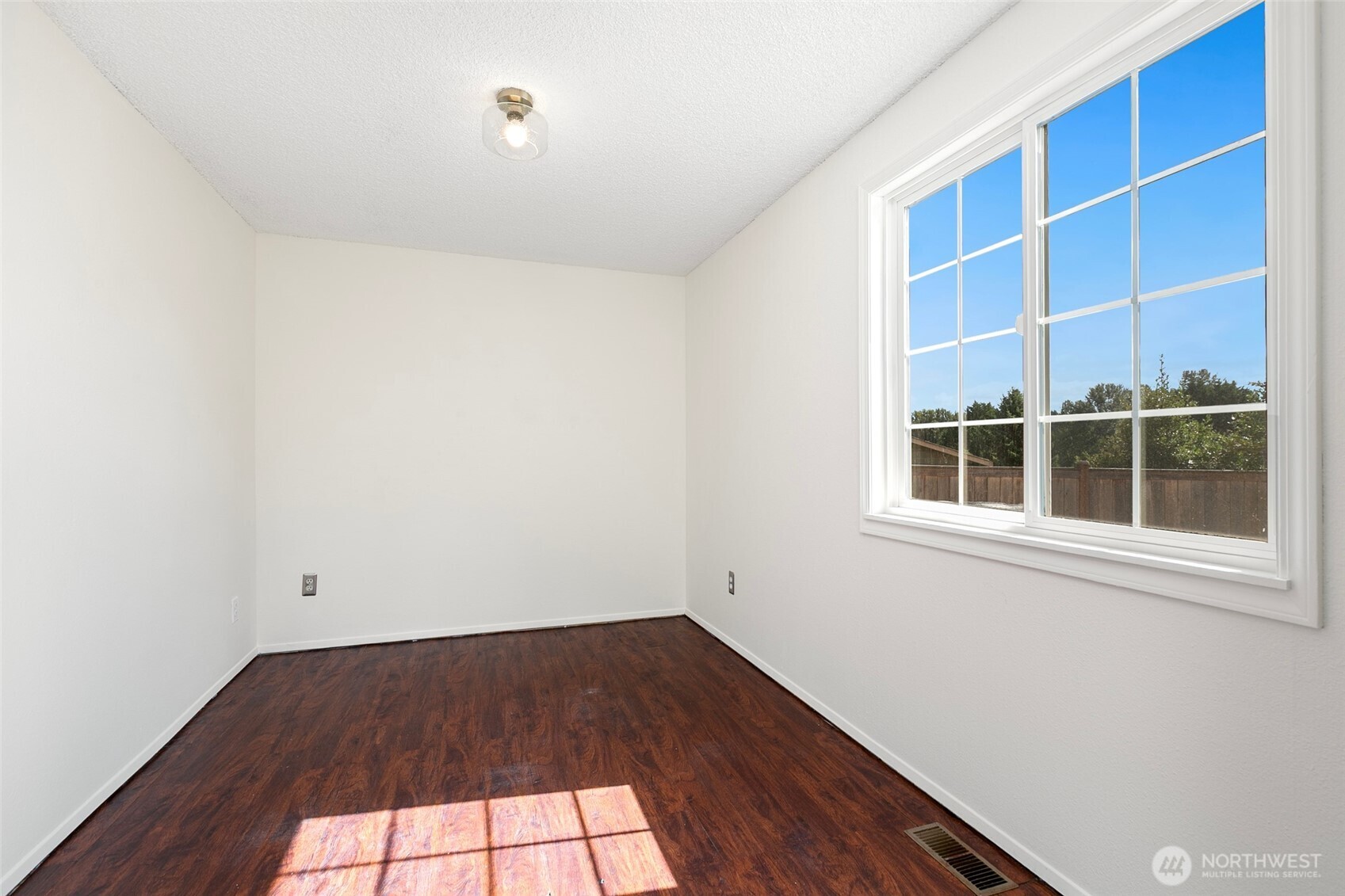 15028 108th Place Northeast Bothell, WA 98011 - Photo 15 of 26 an empty room with wooden floor and windows