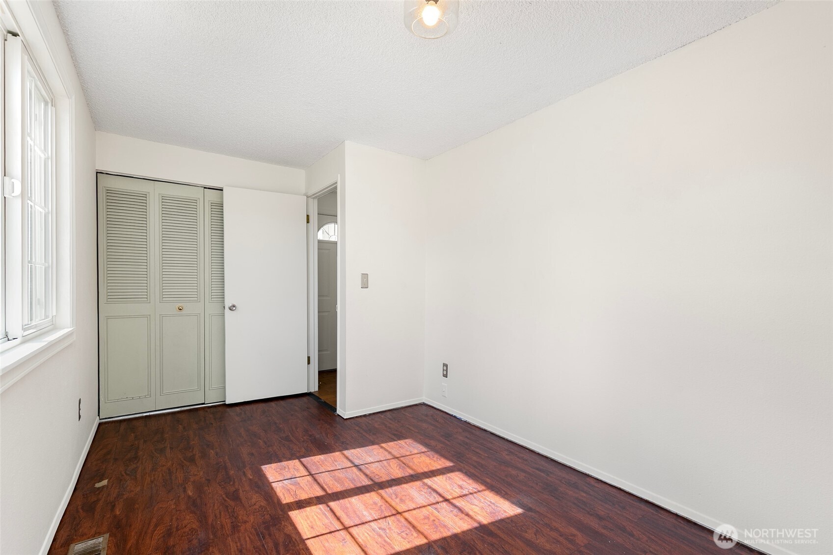 15028 108th Place Northeast Bothell, WA 98011 - Photo 16 of 26 an empty room with wooden floor