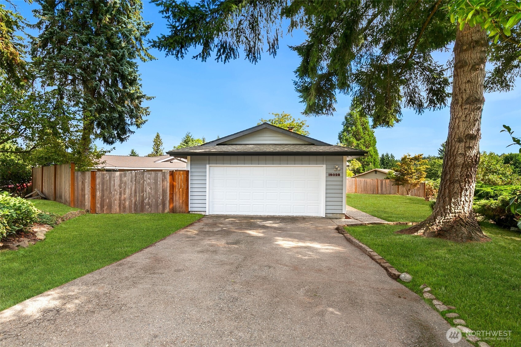 15028 108th Place Northeast Bothell, WA 98011 - Photo 23 of 26 a front view of a house with a yard and garage