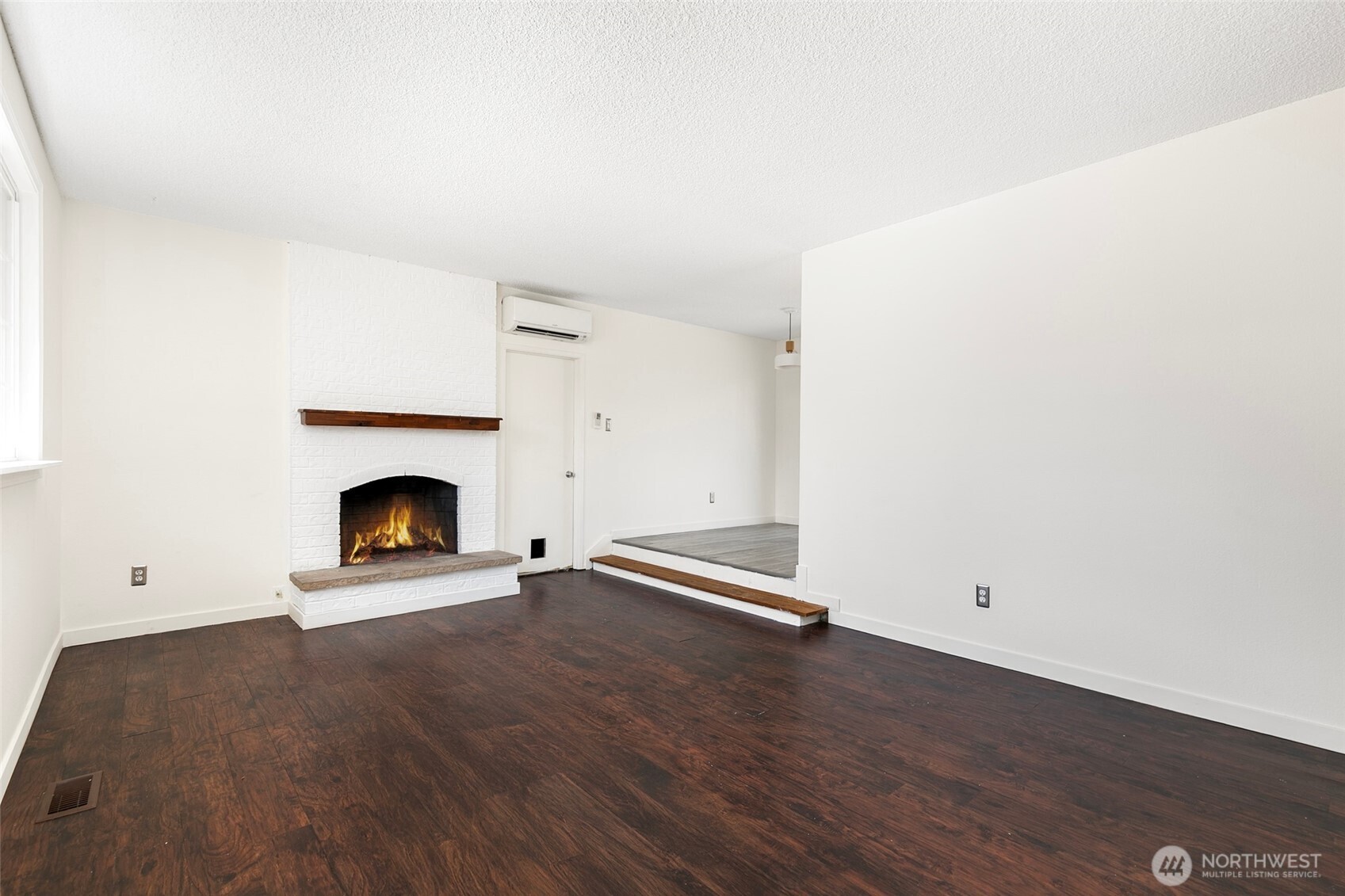 15028 108th Place Northeast Bothell, WA 98011 - Photo 4 of 26 an empty room with wooden floor and a fireplace