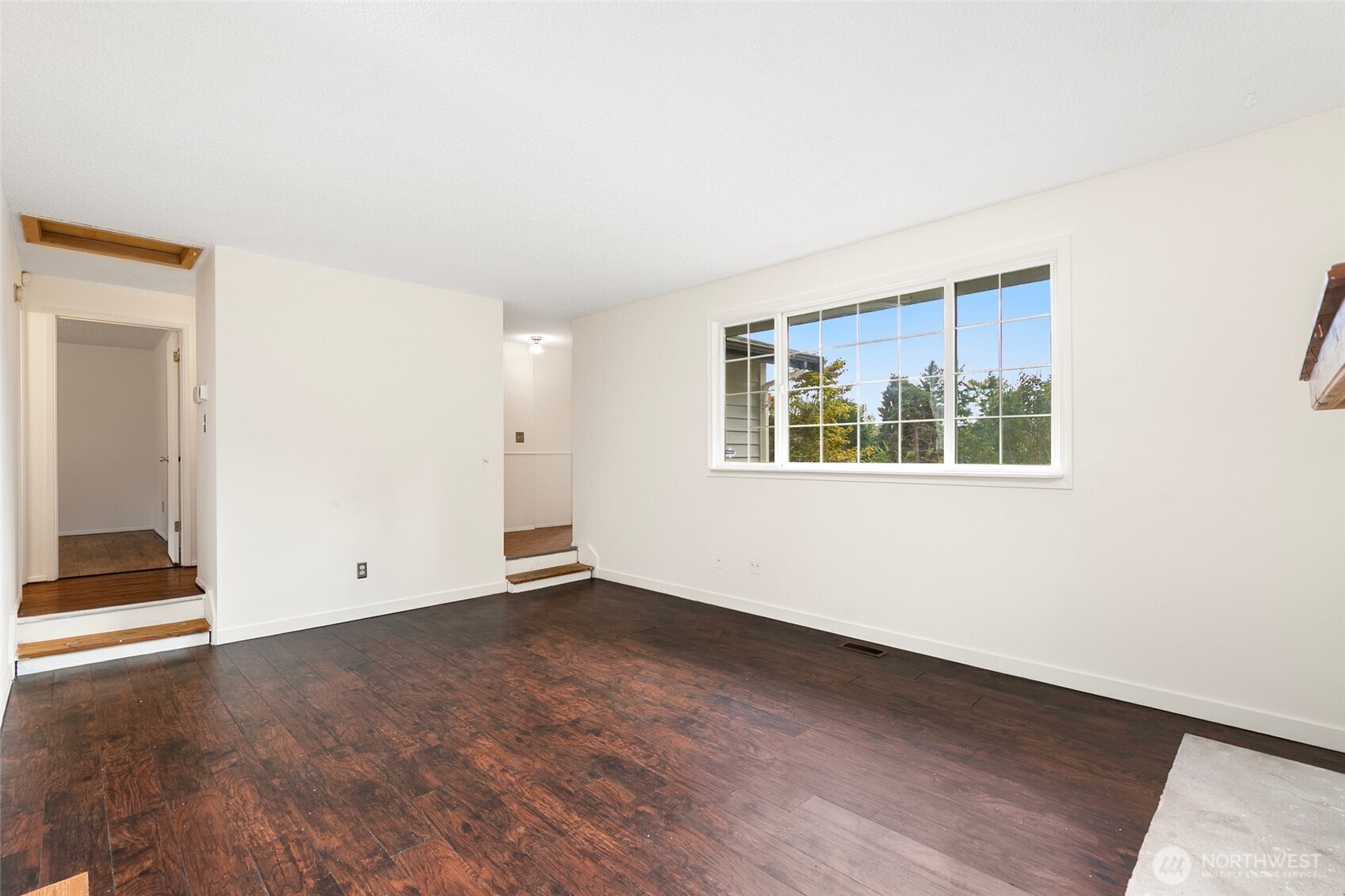 15028 108th Place Northeast Bothell, WA 98011 - Photo 6 of 26 an empty room with wooden floor and windows
