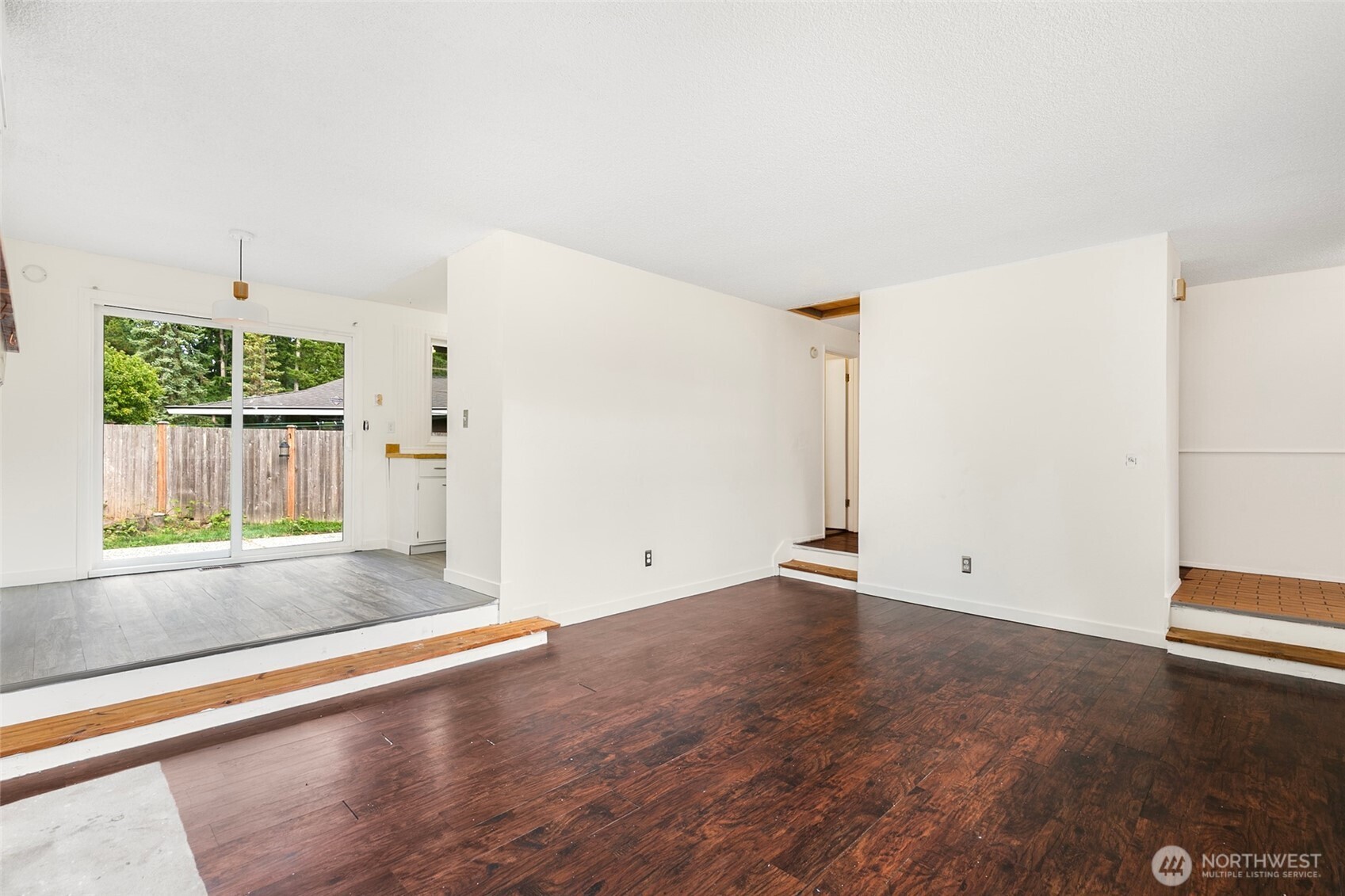 15028 108th Place Northeast Bothell, WA 98011 - Photo 7 of 26 an empty room with wooden floor and windows