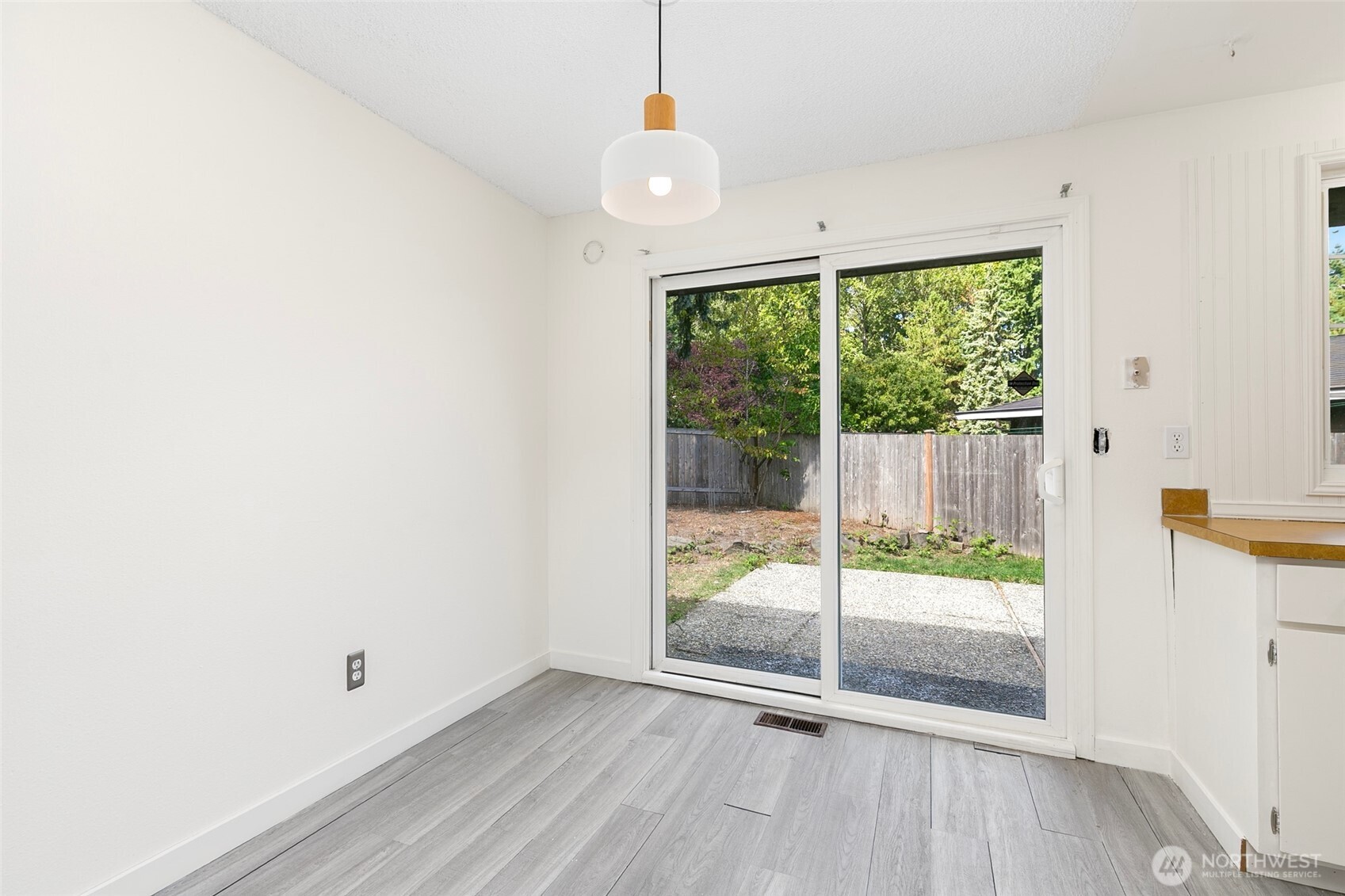 15028 108th Place Northeast Bothell, WA 98011 - Photo 9 of 26 an empty room with wooden floor and windows