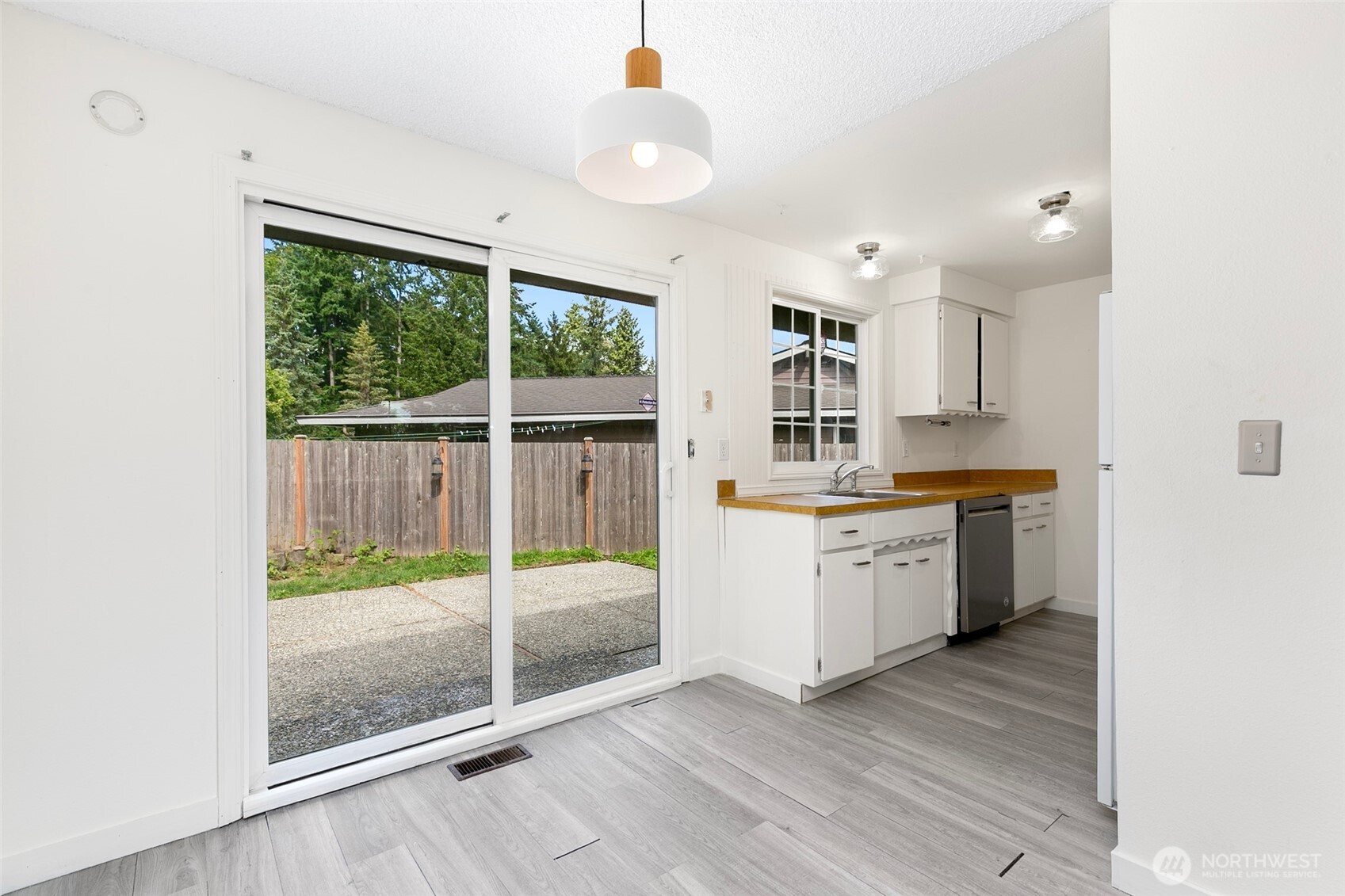 15028 108th Place Northeast Bothell, WA 98011 - Photo 10 of 26 a kitchen with a refrigerator a stove top oven and a large window