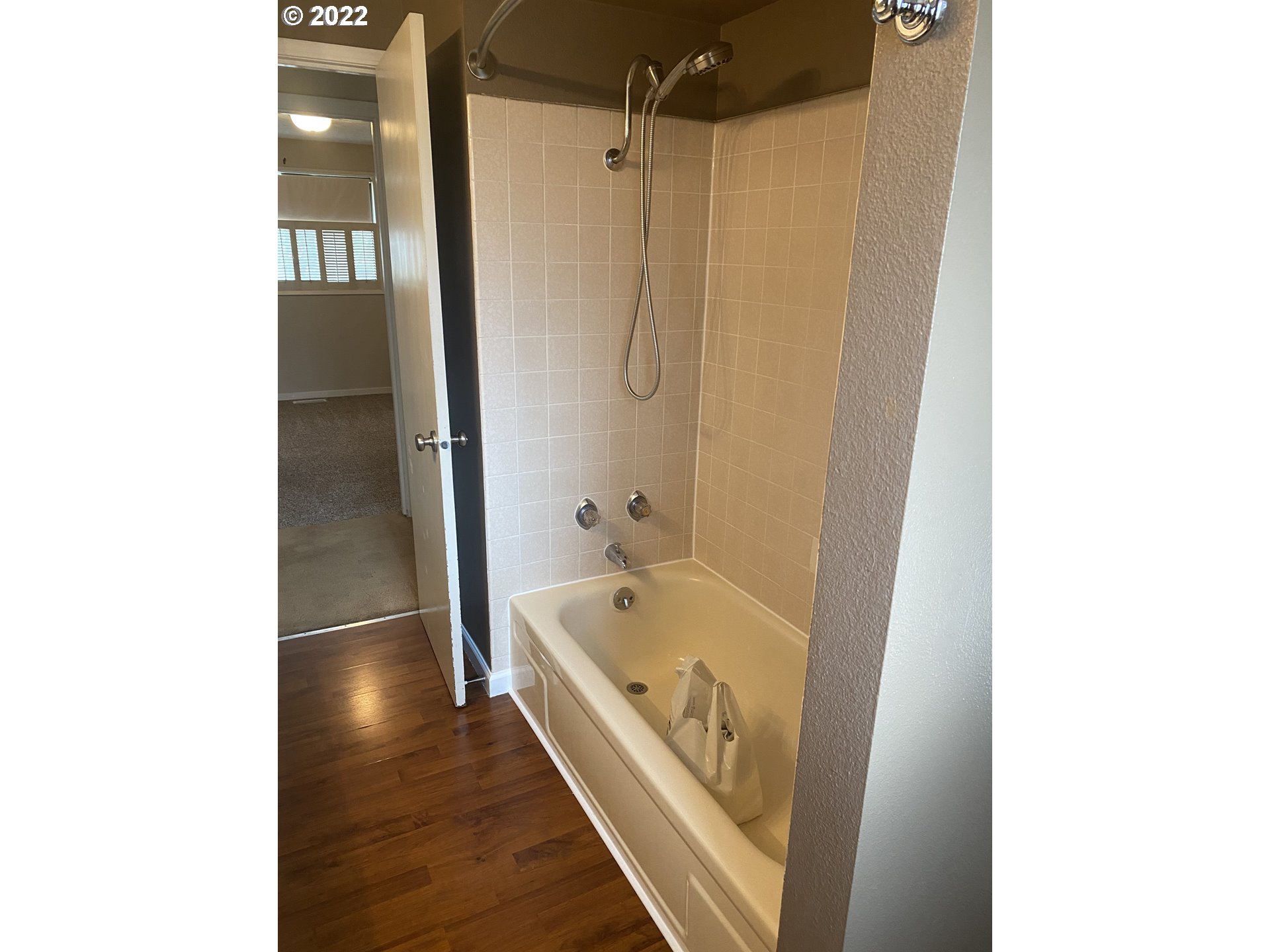 1023 65th Street Springfield, OR 97478 - Photo 17 of 23 a bathroom with a tub and a shower