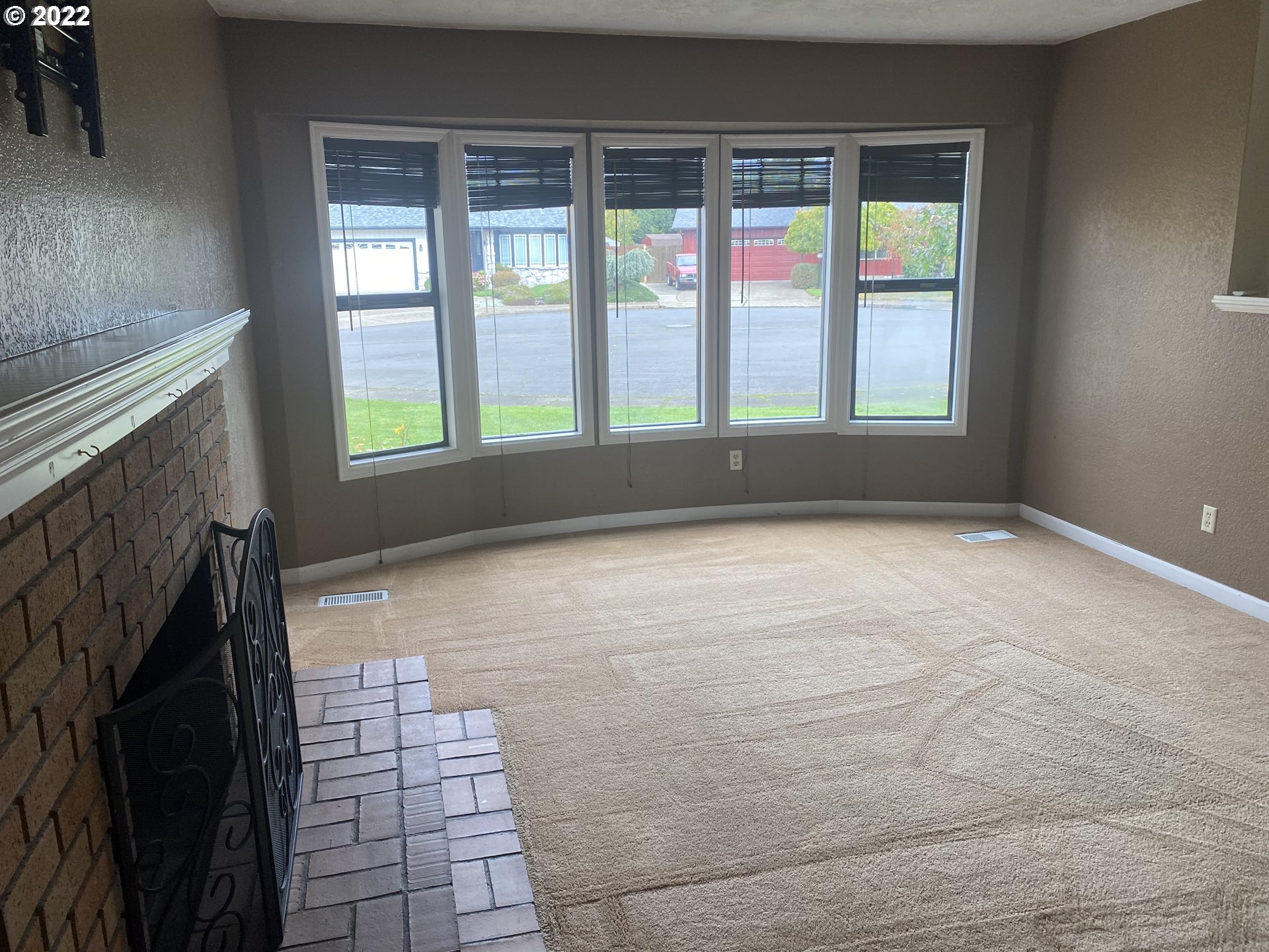 1023 65th Street Springfield, OR 97478 - Photo 3 of 23 a view of an empty room with a fireplace and a window