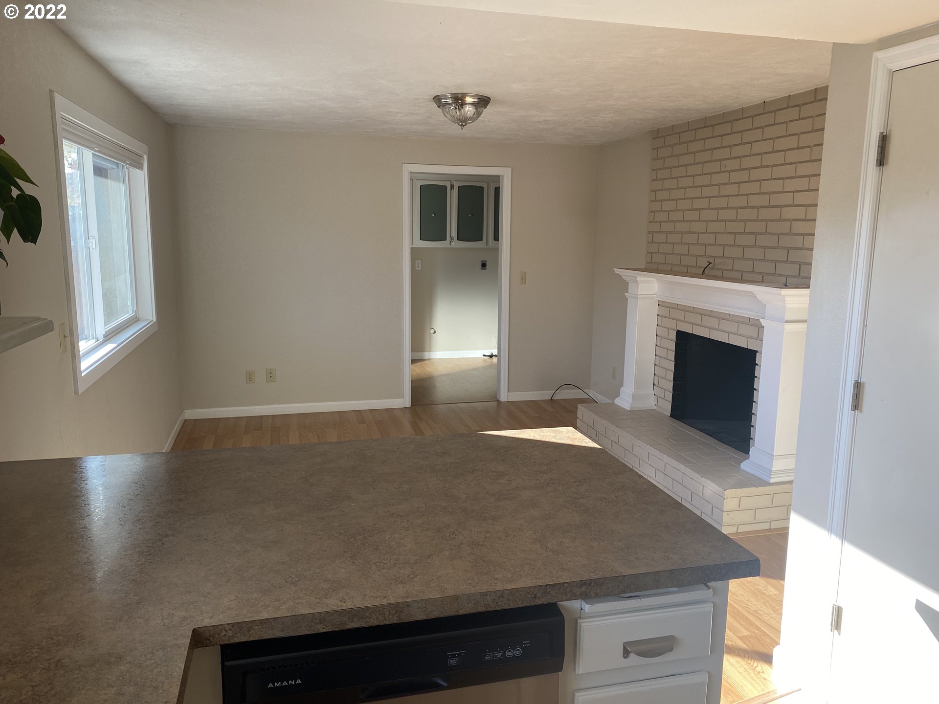 1023 65th Street Springfield, OR 97478 - Photo 4 of 23 a view of kitchen and hall with furniture