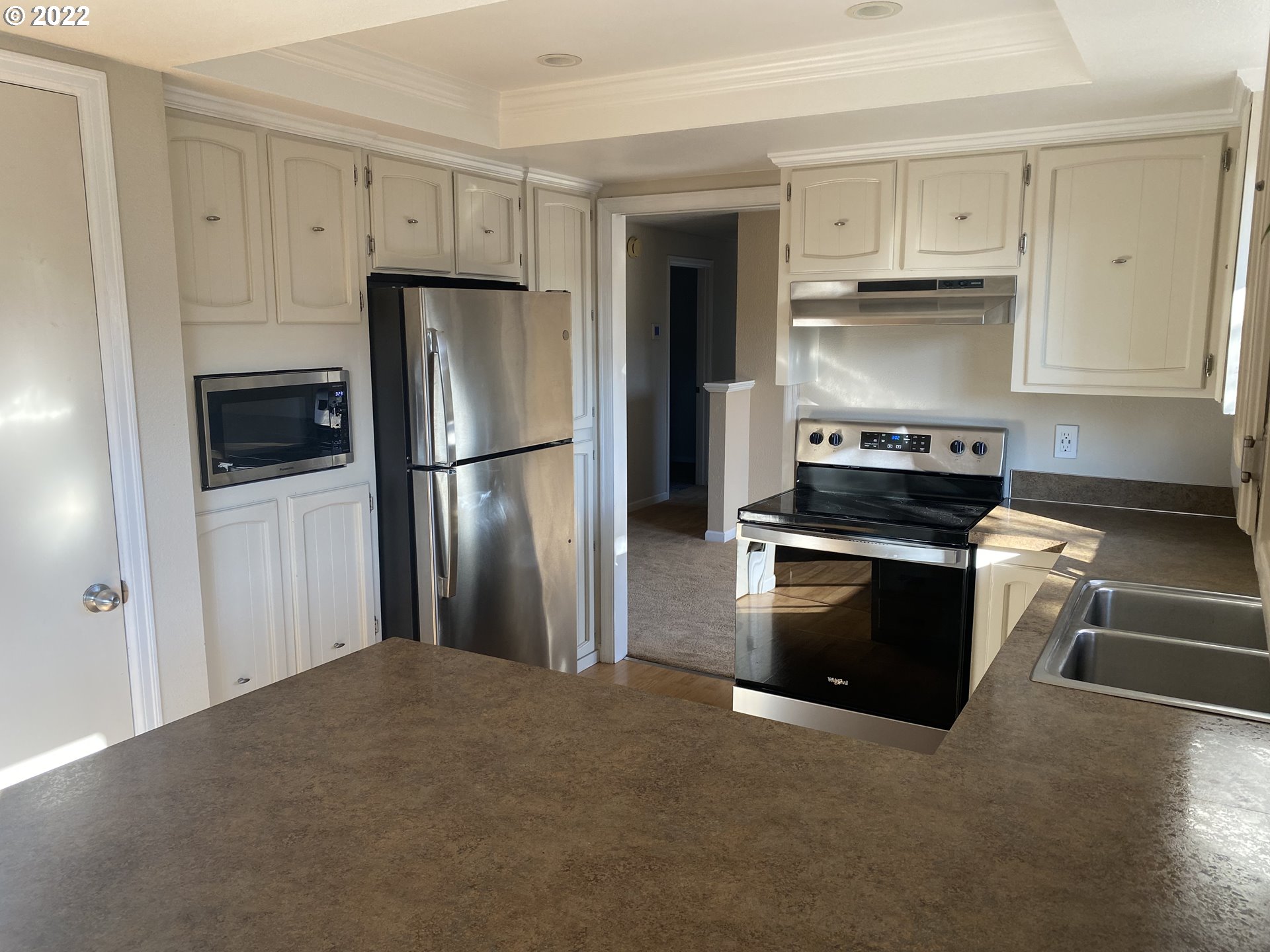 1023 65th Street Springfield, OR 97478 - Photo 8 of 23 a kitchen with cabinets and stainless steel appliances