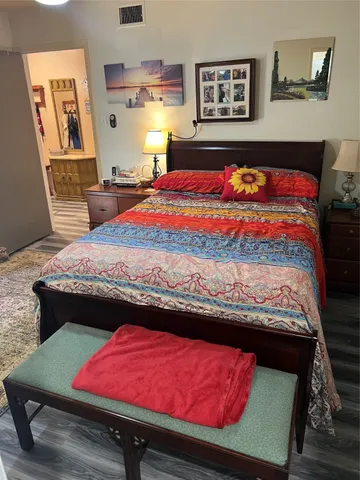 a bedroom with a bed and dresser