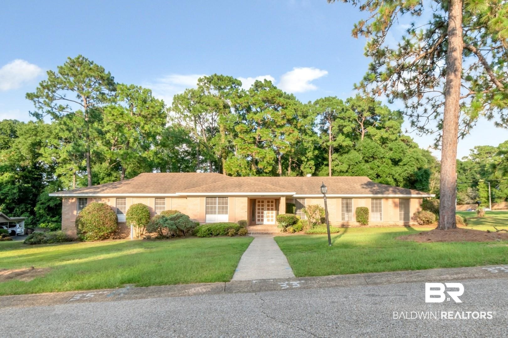 241 Suzanne Circle Mobile, AL 36608 - Photo 1 of 41 Ranch-style home featuring a front yard, french doors, and view of scattered trees