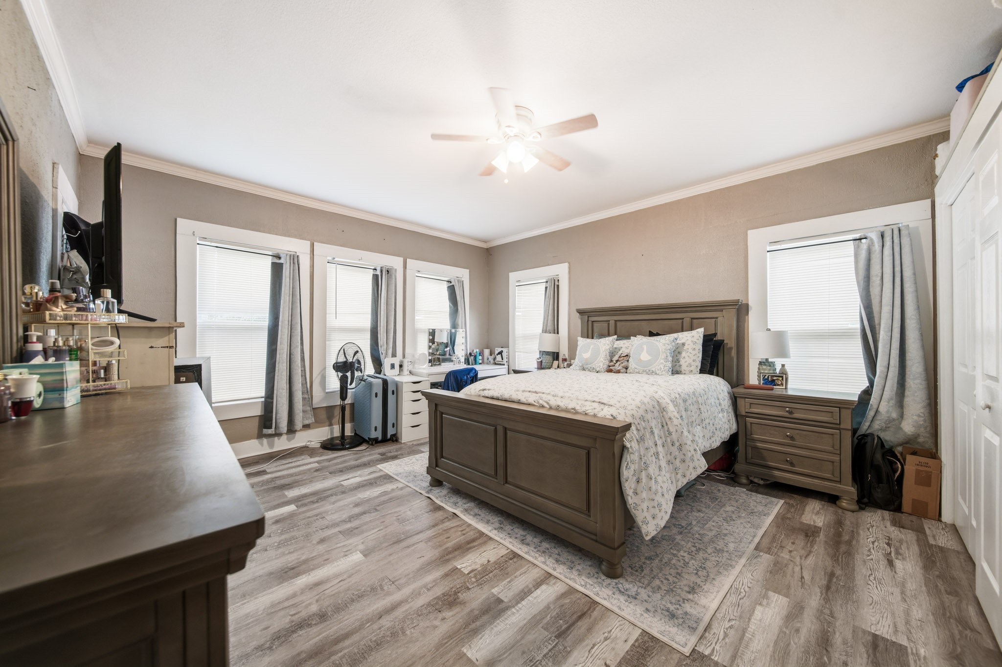 1302 20th Street Huntsville, TX 77340 - Photo 23 of 26 a bedroom with a bed a mirror and furniture
