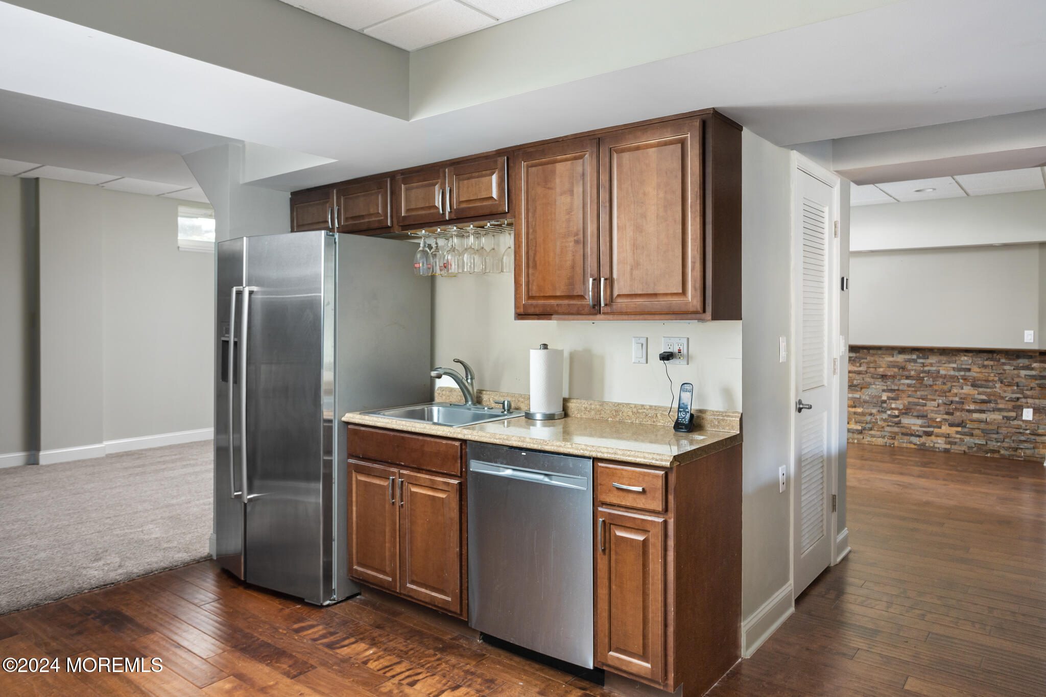 115 Holmes Mill Road Cream Ridge, NJ 08514 - Photo 35 of 49 a kitchen with stainless steel appliances granite countertop a refrigerator a sink and wooden cabinets