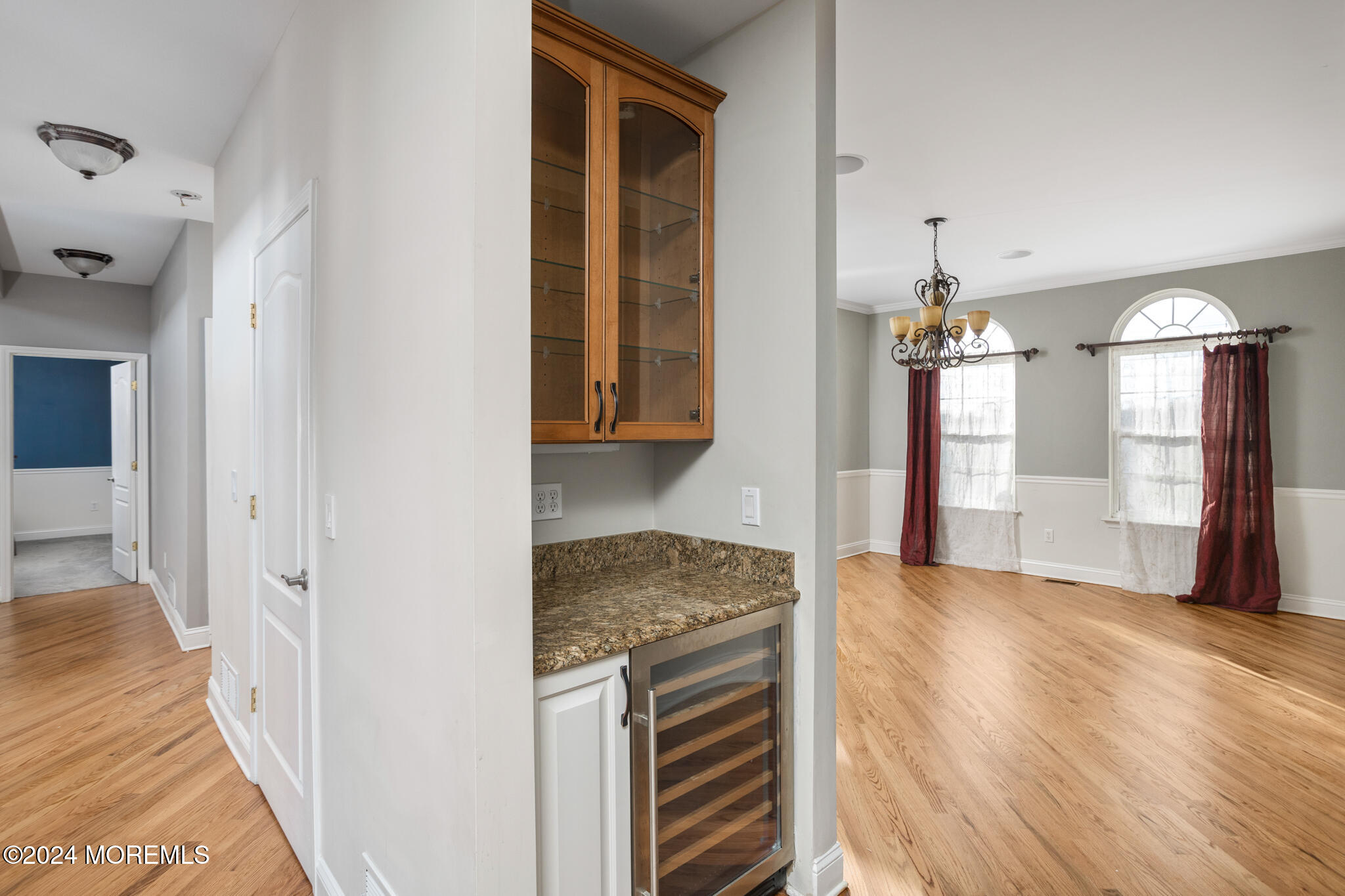 115 Holmes Mill Road Cream Ridge, NJ 08514 - Photo 8 of 49 a view of a hallway with wooden floor and chandelier
