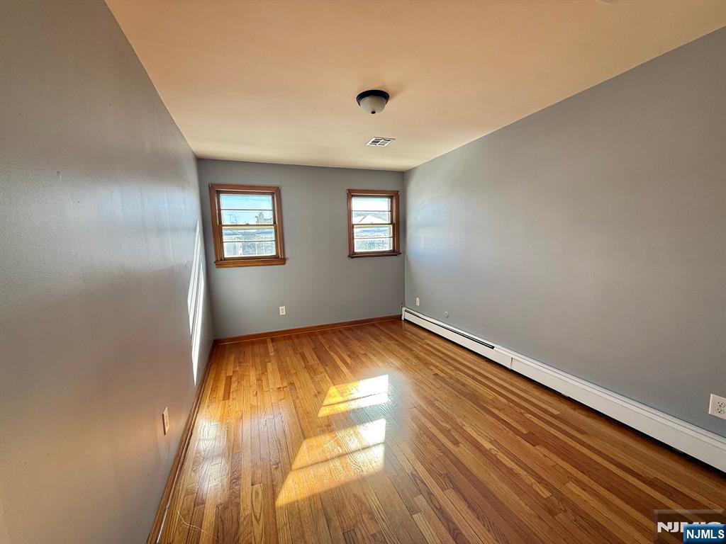 749 Cleveland Avenue, Unit 2 Harrison, NJ 07029 - Photo 13 of 16 wooden floor in an empty room