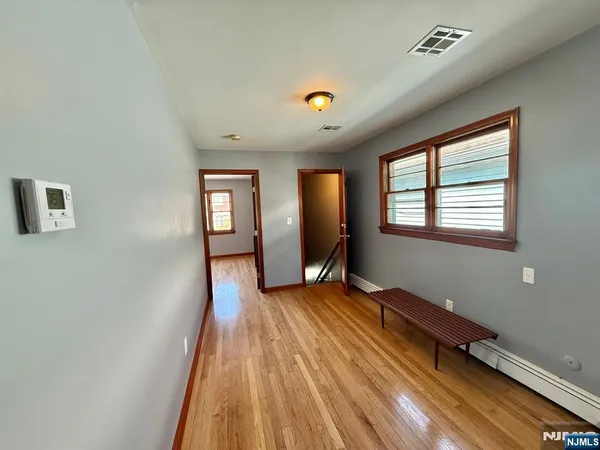 a view of a room with wooden floor and window