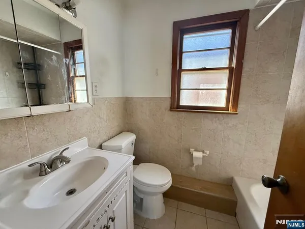 a bathroom with a sink toilet and mirror