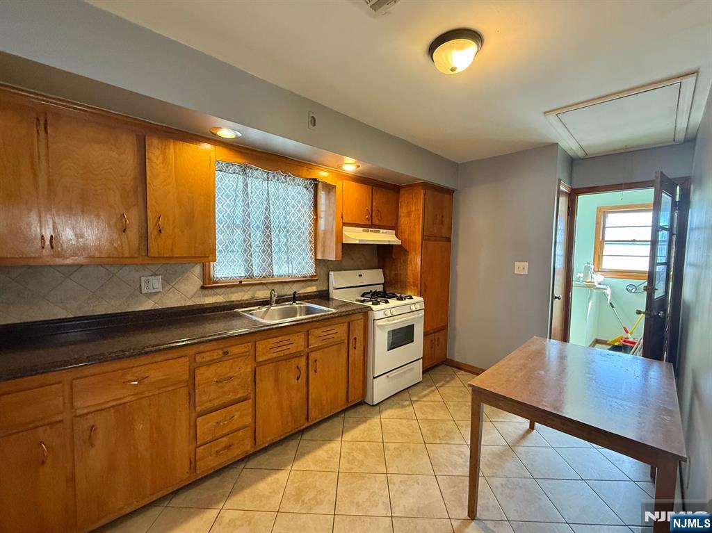 749 Cleveland Avenue, Unit 2 Harrison, NJ 07029 - Photo 2 of 16 a kitchen with stainless steel appliances granite countertop a sink counter space cabinets and a large window