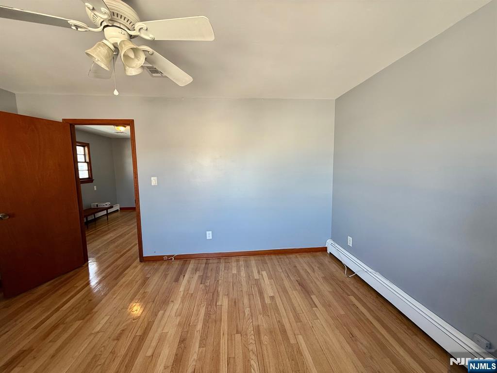 749 Cleveland Avenue, Unit 2 Harrison, NJ 07029 - Photo 4 of 16 wooden floor in an empty room with a window
