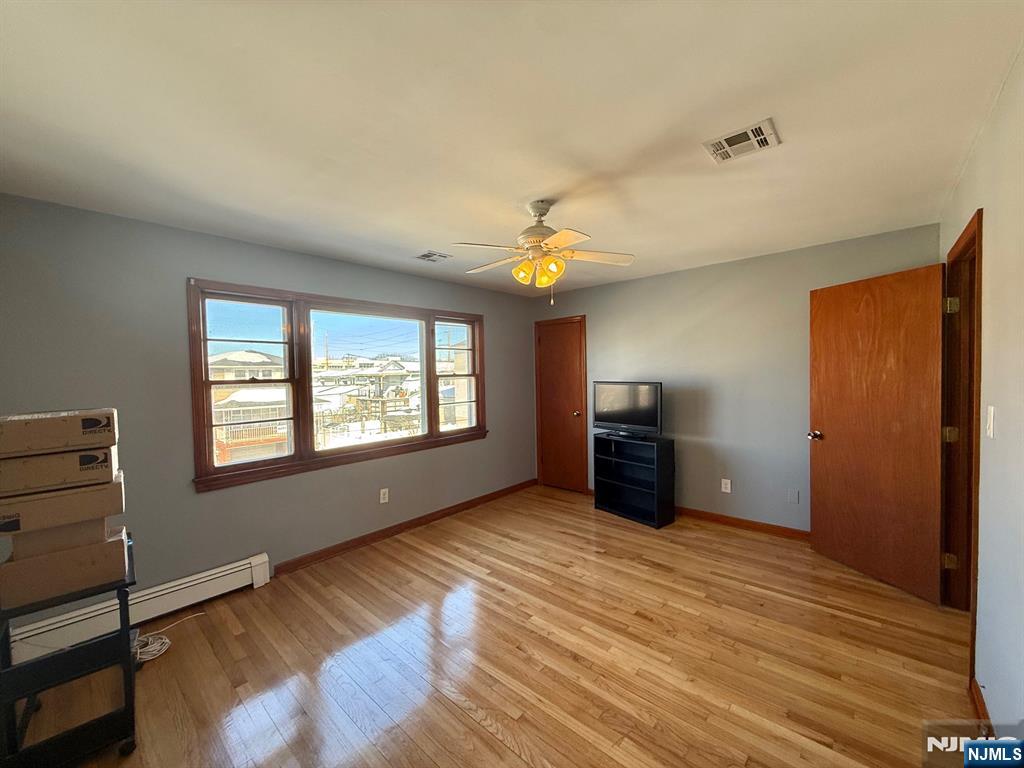 749 Cleveland Avenue, Unit 2 Harrison, NJ 07029 - Photo 6 of 16 a view of empty room with wooden floor and fan