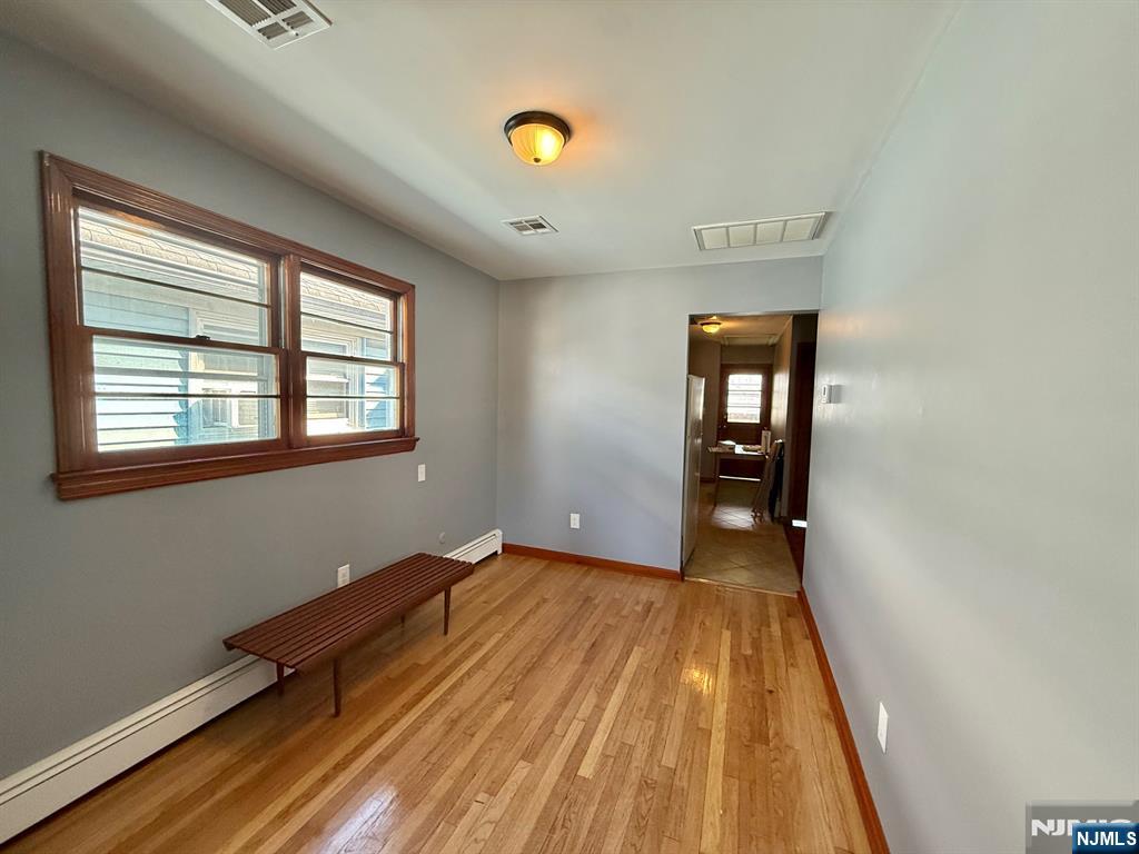 749 Cleveland Avenue, Unit 2 Harrison, NJ 07029 - Photo 8 of 16 a view of a room with wooden floor and windows