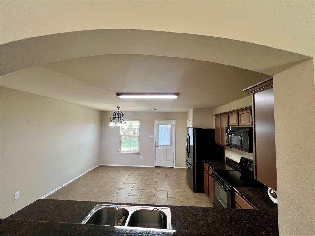 484 Harding Lane Lavon, TX 75166 - Photo 9 of 38 a view of kitchen with refrigerator and window