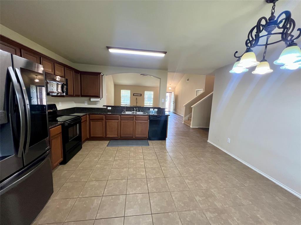 484 Harding Lane Lavon, TX 75166 - Photo 10 of 38 a large kitchen with a stove a sink dishwasher and a refrigerator