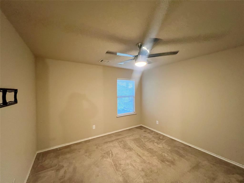 484 Harding Lane Lavon, TX 75166 - Photo 32 of 38 an empty room with a chandelier fan and windows