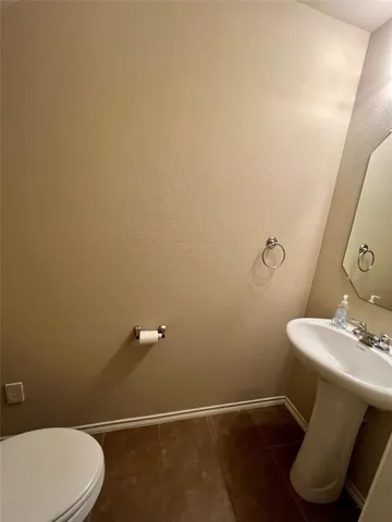 an empty room with a chandelier fan and windows