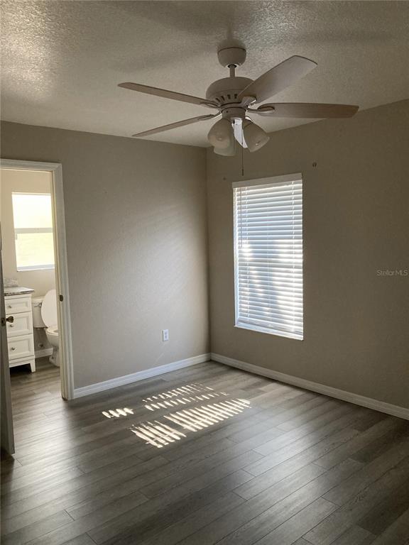 1088 Nomad Road Punta Gorda, FL 33983 - Photo 6 of 13 a view of empty room with wooden floor and fan