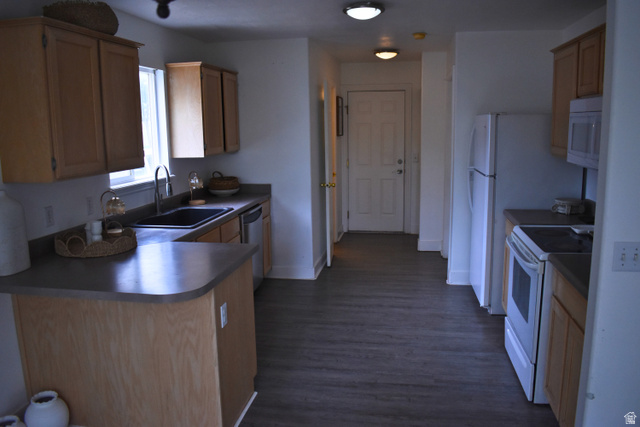 3327 East Windhover Road Eagle Mountain, UT 84005 - Photo 9 of 38 Kitchen featuring wood-finish cabinetry, dark countertops, and wood-finish flooring