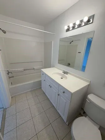 a bathroom with a sink a toilet and mirror